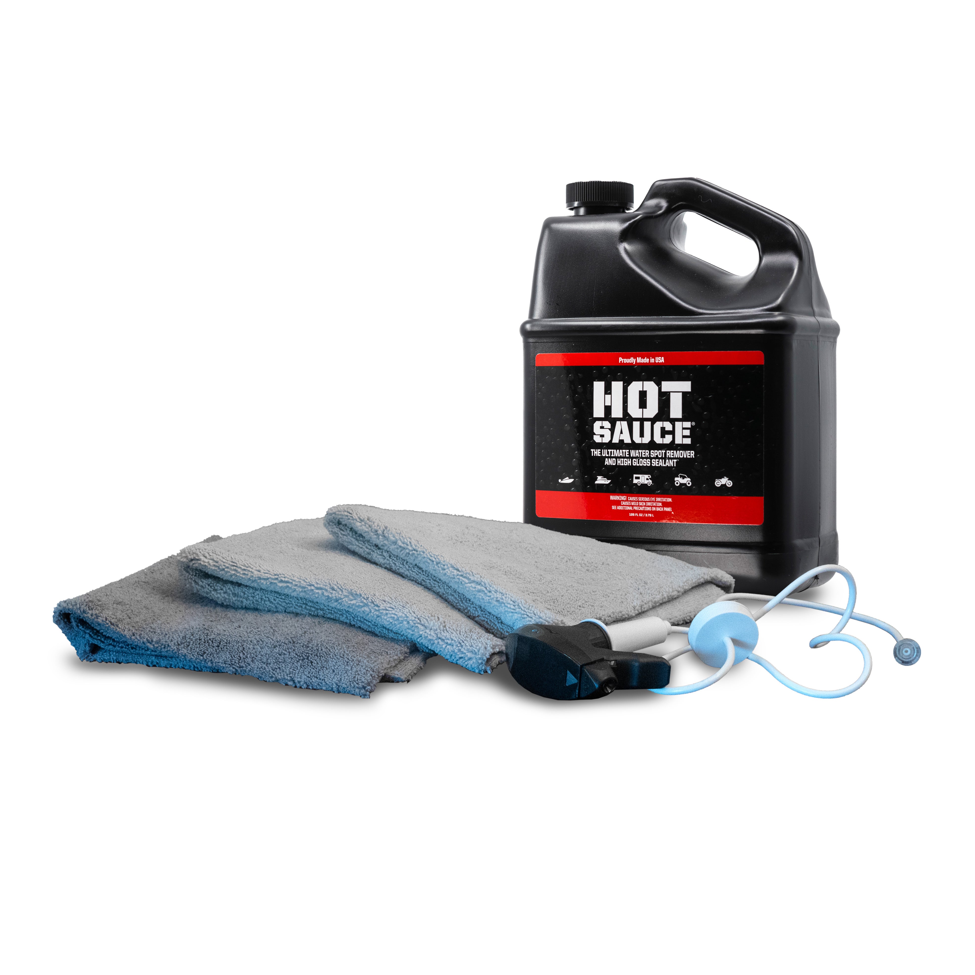 Premium Hot Sauce To-Go Kit featuring a large bottle of cleaning solution, microfiber towels, and detailing tools for vehicle care.