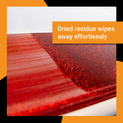 Close-up of a shiny red surface showing easy removal of dried residue with Quickie Sauce detailing product.