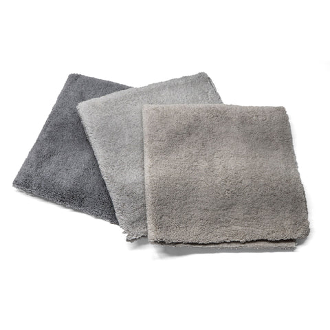 Three grey-shade microfiber towels in varying tones, ideal for cleaning and detailing vehicles for a professional finish.