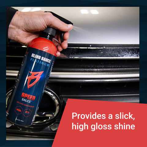 Bling Sauce Speed Sauce bottle held above a vehicle hood, showcasing its ability to deliver a slick, high gloss shine.