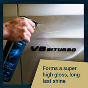 Hand holding a spray bottle of Secret Sauce, applying it to a vehicle's surface to create a high gloss finish.
