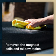 Hand using a microfiber cloth to clean a vehicle surface, effectively removing tough soils and mildew stains.