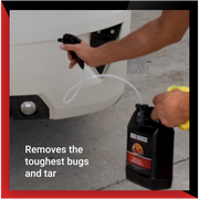A person using Bug Sauce spray on a vehicle's front to effectively remove tough bugs and tar.
