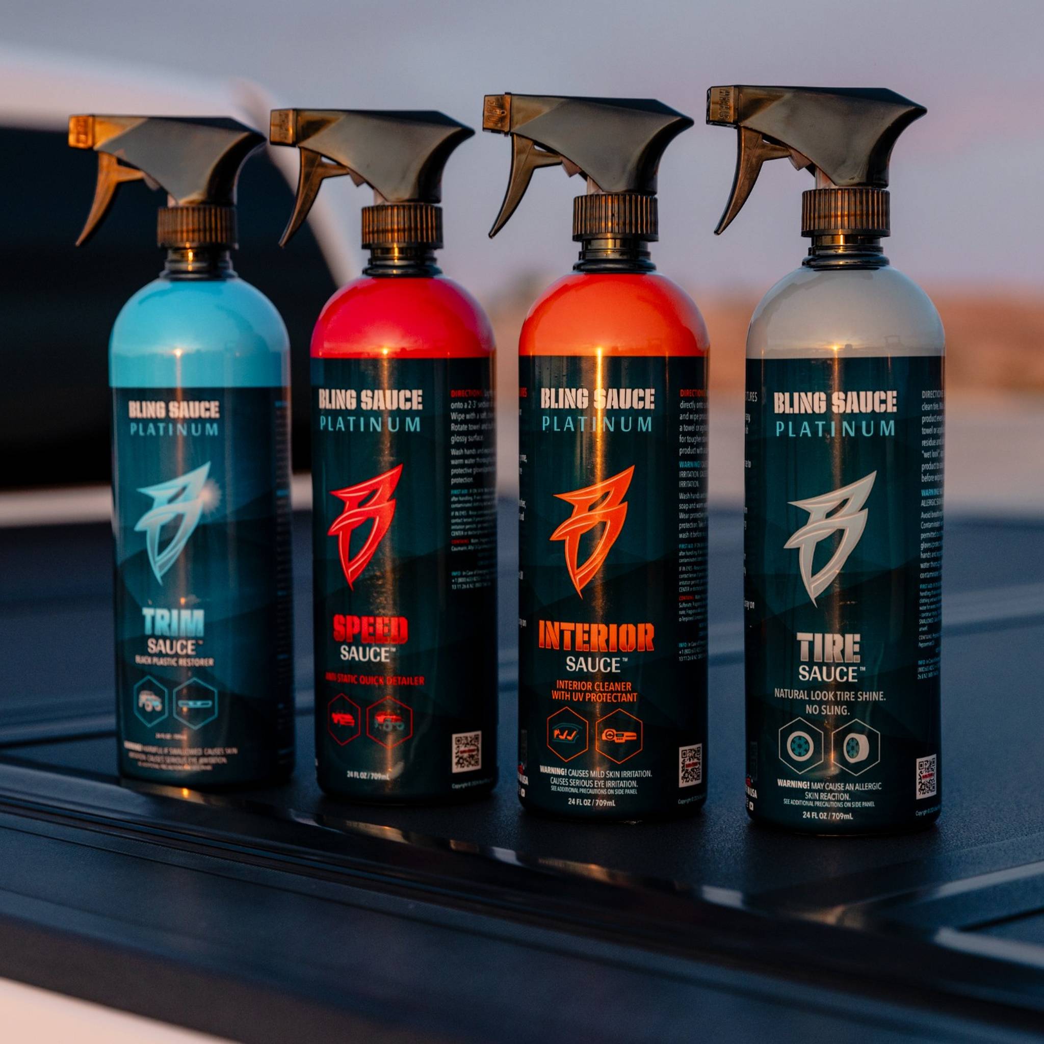 Four bottles of Mrs. Swoop’s SEXYFAST Kit, featuring trim, speed, interior, and tire sauces, arranged on a surface.