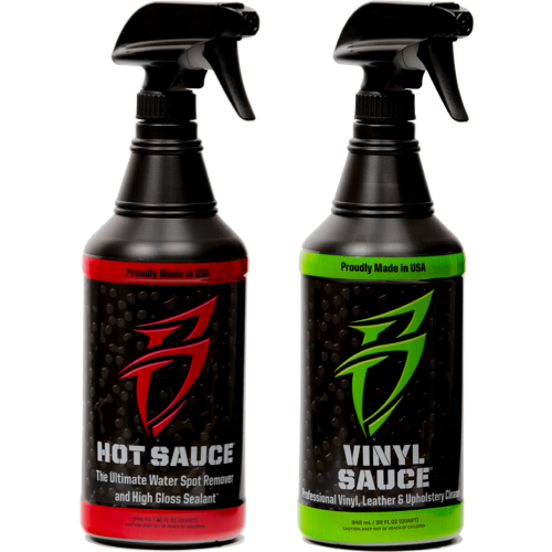 Two empty quart spray bottles labeled "Hot Sauce" and "Vinyl Sauce," designed for cleaning and sealing surfaces.